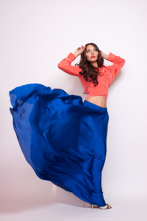 Fashion photo of young magnificent woman in blue dress. Studio photoの写真素材