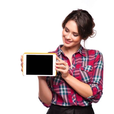 Happy smiling beautiful young woman showing blank tablet pc for copyspace, isolated over white backgroundの写真素材