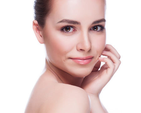 Beautiful Young Woman Touching Her Face.Fresh Healthy Skin.Isolated on Whiteの写真素材