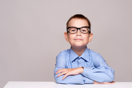 Happy little boy with books isolated on white backgroundの写真素材