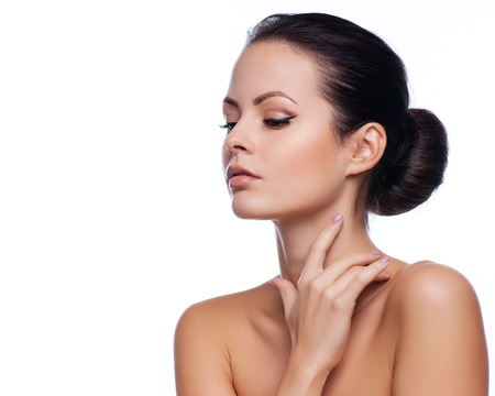 Beautiful Young Woman Touching Her Face.Fresh Healthy Skin.Isolated on Whiteの写真素材