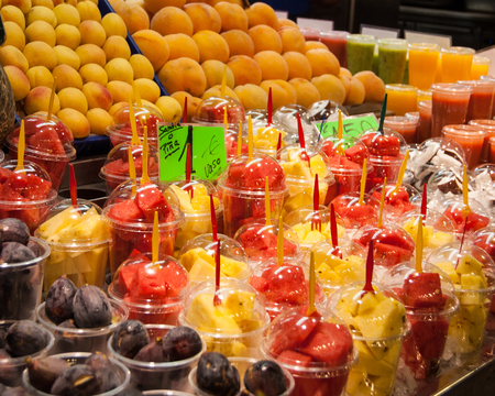 A variety of colorful, fruity drinks on ice in a Barcelona, Spain marketの写真素材