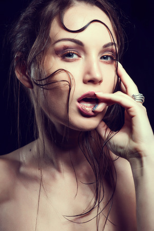 High fashion look.glamor closeup portrait of beautiful sexy stylish blond Caucasian young woman model with bright makeup, with red lips, with perfect clean skin with colorful accessoriesの写真素材