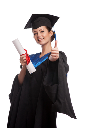 A woman with a degree in her hand as she looks at the cameraの写真素材