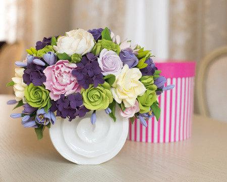 Rose flower bouquet and gift box on wooden tableの写真素材