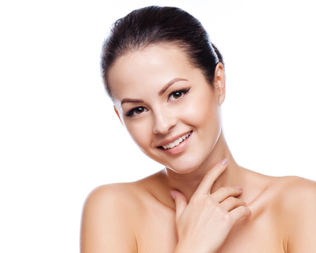 Beautiful Young Woman Touching Her Face.Fresh Healthy Skin.Isolated on Whiteの写真素材