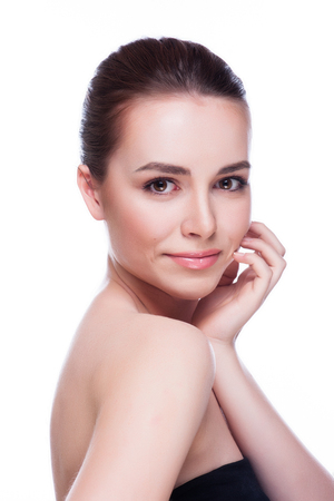 Beautiful Young Woman Touching Her Face.Fresh Healthy Skin.Isolated on Whiteの写真素材