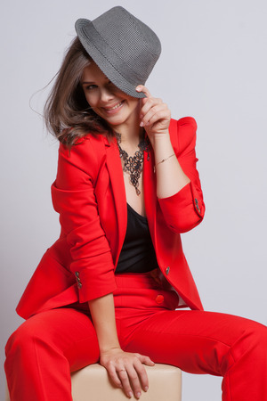 Portrait of a sexy young lady in a red suitの写真素材