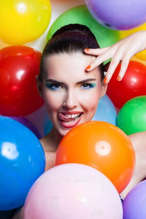 Beauty Girl Portrait with Colorful Makeup, Nail polish and Accessories. Colourful Studio Shot of Funny Woman. Vivid Colors.の写真素材