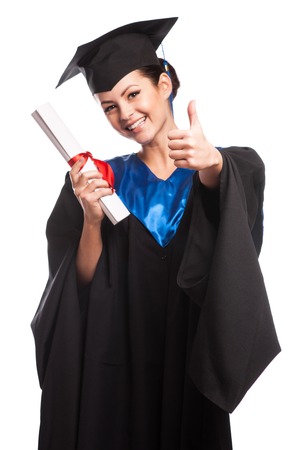 young woman college graduate portrait wearing cap and gown with diploma isolated on white backgroundの写真素材