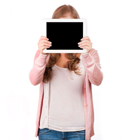 Pretty red-haired woman holding mini tablet pc before face, Studio Shot