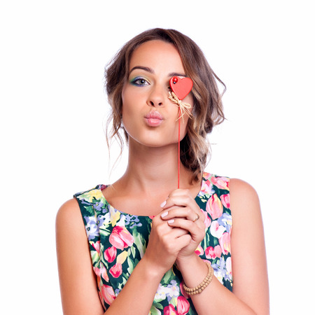 Beautiful lady blows a kiss, isolated on whiteの写真素材