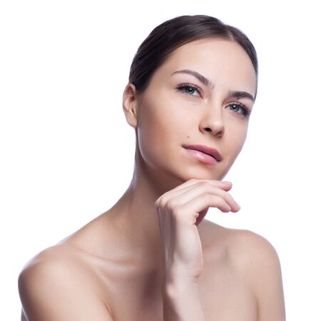 Beautiful face of young adult woman with clean fresh skin - isolated on white.の写真素材