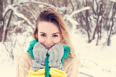 Beautiful winter portrait of young woman in the winter snowy scenery.の写真素材