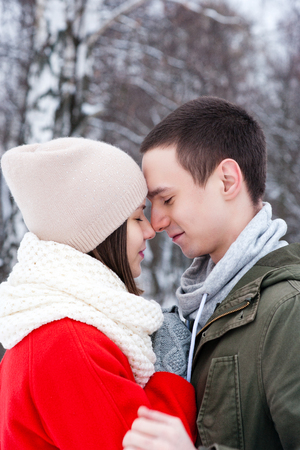 Happy Young Couple in Winter Park having fun.Family Outdoors. love kissの写真素材