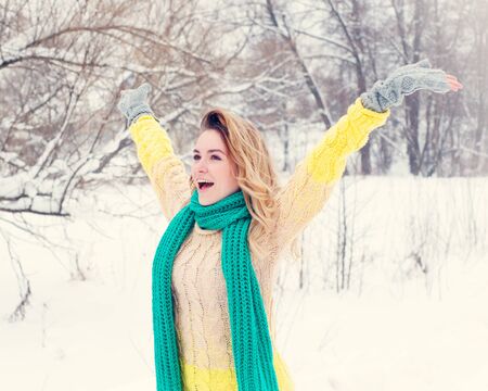 Beautiful winter portrait of young woman in the winter snowy scenery.の写真素材