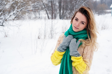 Beautiful winter portrait of young woman in the winter snowy scenery.の写真素材
