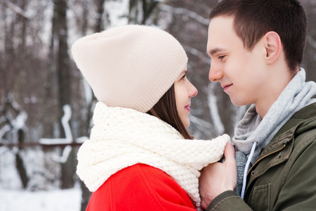 Happy Young Couple in Winter Park having fun.Family Outdoors. love kissの写真素材