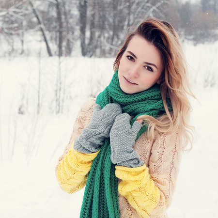Beautiful winter portrait of young woman in the winter snowy scenery.の写真素材
