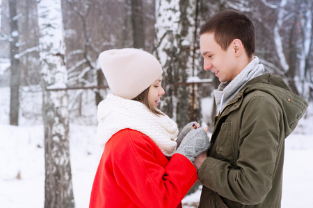 Happy Young Couple in Winter Park having fun.Family Outdoors. love kissの写真素材