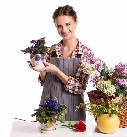 Gardening  Woman with flowers  Isolated over white background.の写真素材