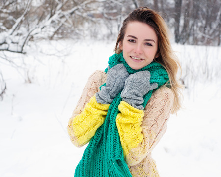 Beautiful winter portrait of young woman in the winter snowy scenery.の写真素材