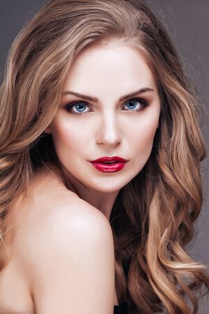 Portrait of wonderful young blonde woman with long hair looking at cameraの写真素材
