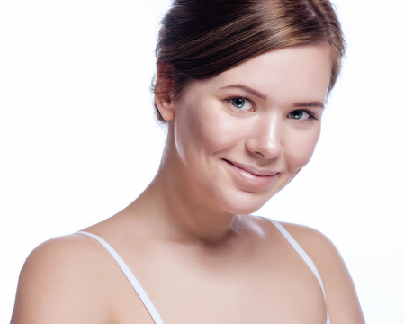 Beautiful face of young adult woman with clean fresh skin - isolated on white.の写真素材