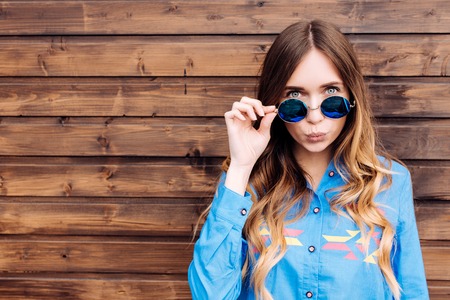 Cool hipster student woman wearing eyewear glasses . Caucasian female university student looking at camera smiling happy.の写真素材