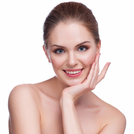 Beautiful face of young adult woman with clean fresh skin - isolated on white.の写真素材