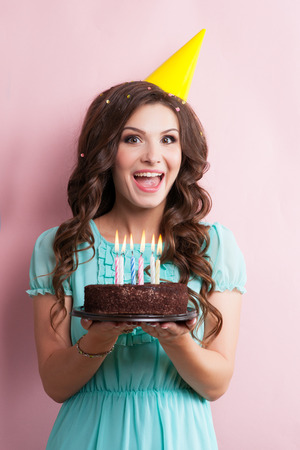 attractive teenage girl celebrating her birthday with cake.の写真素材
