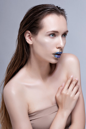 Beauty Woman with Perfect Makeup. Beautiful Professional Holiday Make-up. Purple Lips and Nails. Beauty Girl's Face .の写真素材