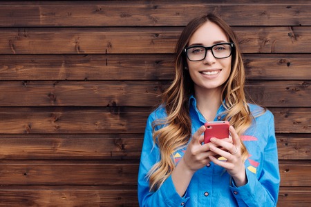 Beautiful young hipster woman using smart phone.の写真素材