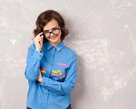 Cool hipster student woman wearing eyewear glasses . Caucasian female university student looking at camera smiling happy.の写真素材