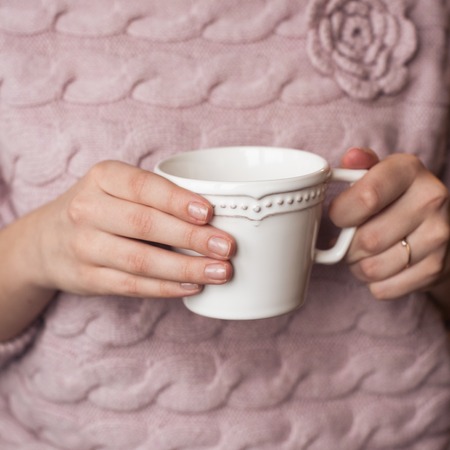 beautiful woman's hands with a cup.の写真素材