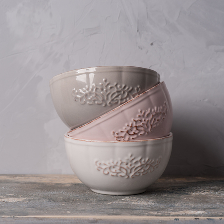 Six ceramic bowls in a stack. Isolated on gray background.の写真素材