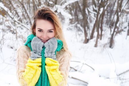 Beautiful winter portrait of young woman in the winter snowy scenery.の写真素材