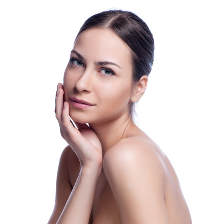Beautiful face of young adult woman with clean fresh skin - isolated on white.の写真素材