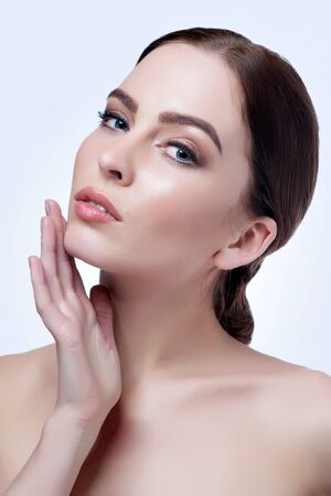 Beautiful face of young adult woman with clean fresh skin - isolated on white.の写真素材