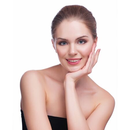 Beautiful Young Woman Touching Her Face.Fresh Healthy Skin.Isolated on White.の写真素材