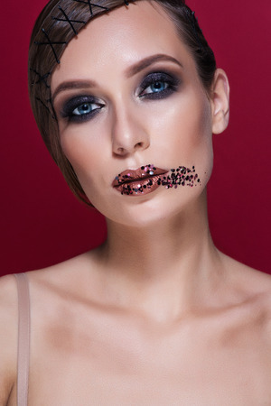 Beautiful Fashion Luxury Makeup, long eyelashes, perfect skin facial make-up. Beauty Brunette model woman holiday make up close up. Eyelash extensions, false eyelashes.の写真素材