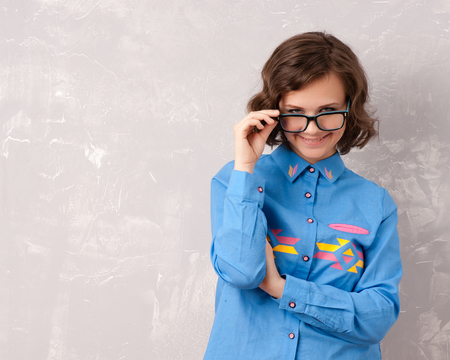 Cool hipster student woman wearing eyewear glasses . Caucasian female university student looking at camera smiling happyの写真素材