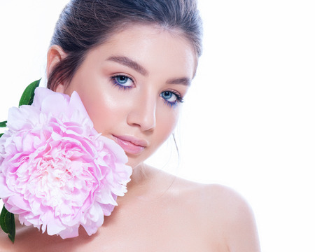 portrait of attractive caucasian smiling woman blond with roses isolated on white studio shot.の写真素材