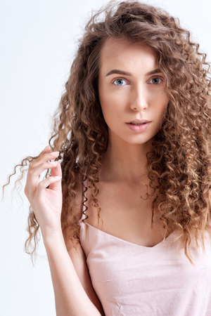 Beautiful Curly Hair. Smiling Girl With Healthy Wavy Long Blonde Hair. Portrait Happy Woman With Beauty Face, Sexy Makeup And Perfect Hair Curls. Volume, Hairstyle, Hairdressing Concept. High Quality.の写真素材