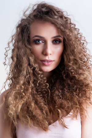 Beautiful Curly Hair. Smiling Girl With Healthy Wavy Long Blonde Hair. Portrait Happy Woman With Beauty Face, Sexy Makeup And Perfect Hair Curls. Volume, Hairstyle, Hairdressing Concept. High Quality.の写真素材