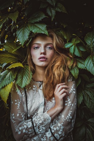 stylish hipster woman with fern leaf embracing. girl portrait with natural herb, boho sensual bride. romantic moment. rustic eco wedding concept. beautiful woman relaxing.の写真素材