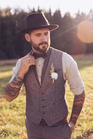 Portrait of stylish beard, male with tattoos on his arms. Wedding portrait.の写真素材