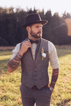 Portrait of stylish beard, male with tattoos on his arms. Wedding portrait.の写真素材