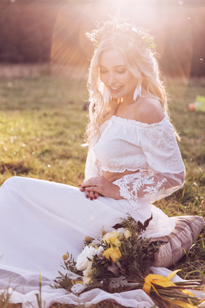 Enchanting Bride with Tiara on Nature Background. Modern Bridal Style. Boho Fashion Wedding. Filtered Cross Processed Photo with Bokeh and Copy Space.の写真素材