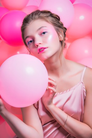 Beauty Girl Face with Colorful Nail polish. Colourful Studio Shot of young Woman. Vivid Colors. Colourful Manicure and fashion Makeup. Rainbow Colors.の写真素材